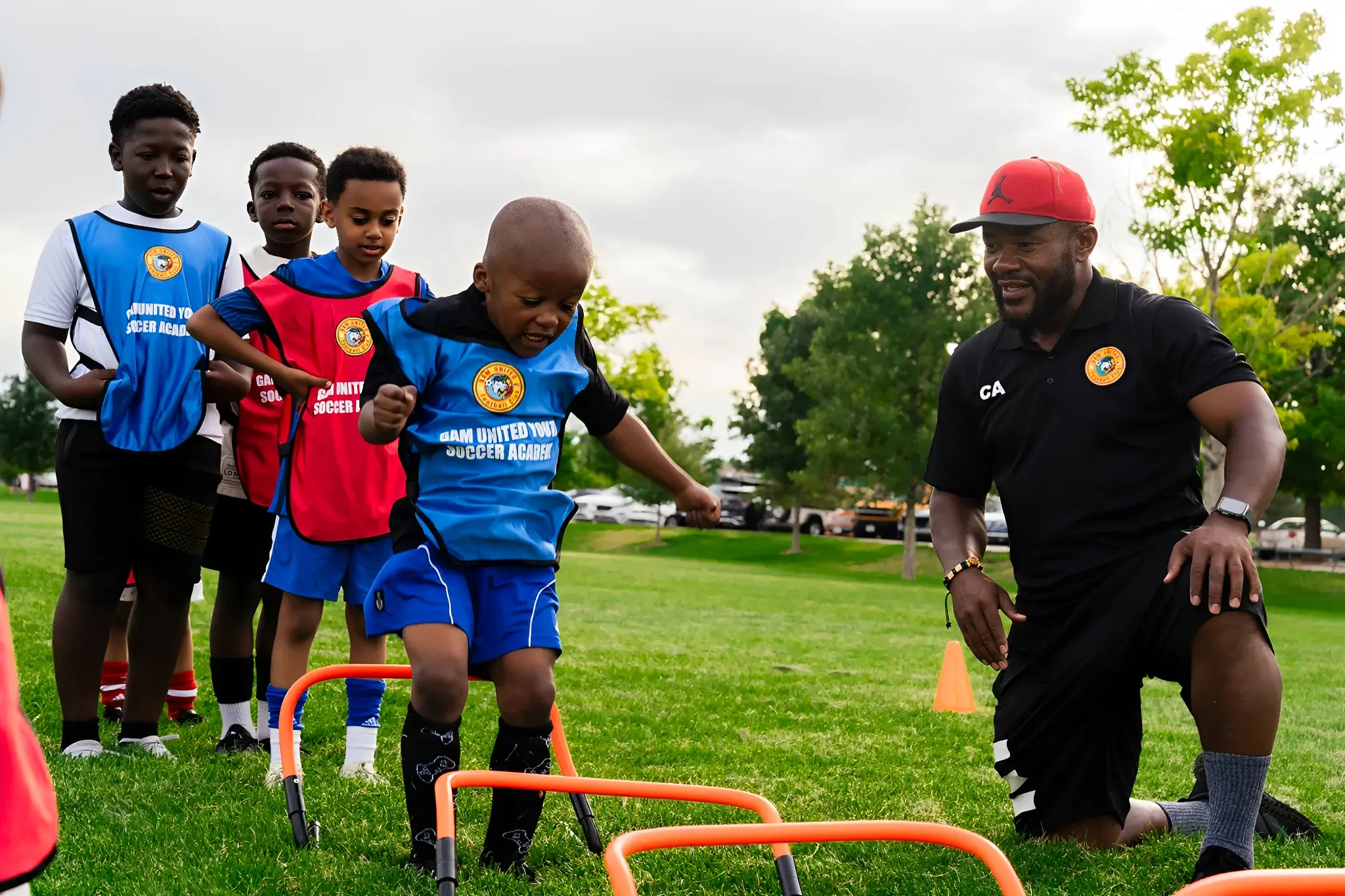 Coach guiding kids through sports drills