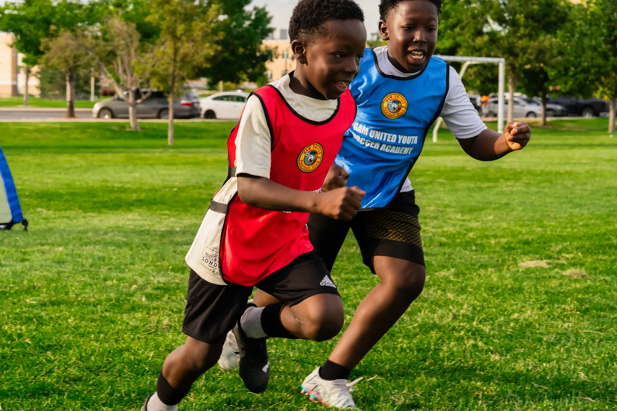 Kids playing soccer on a grassy field.
